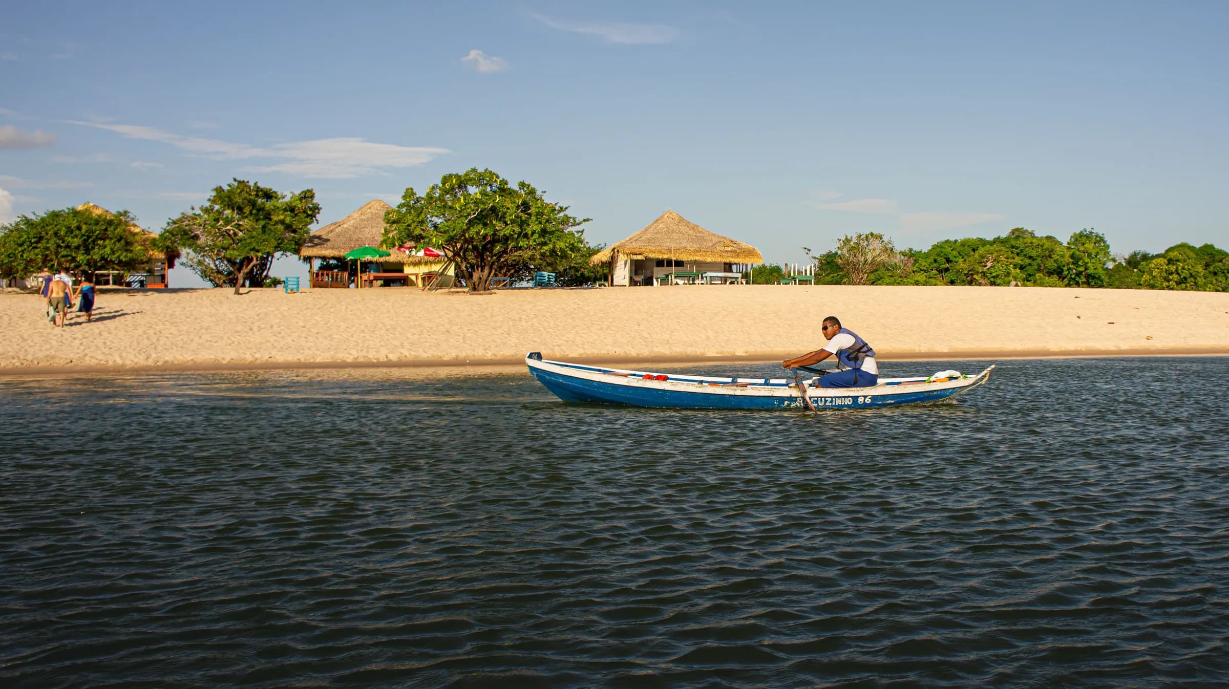 Ilha do Amor em Alter do Chão, com barracas de praia na faixa de areia branca e um canoeiro no Rio Tapajós